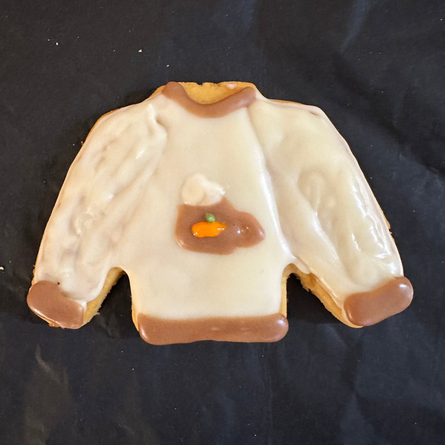 A dog treats designed to look like a  a pumpkin spice sweater.