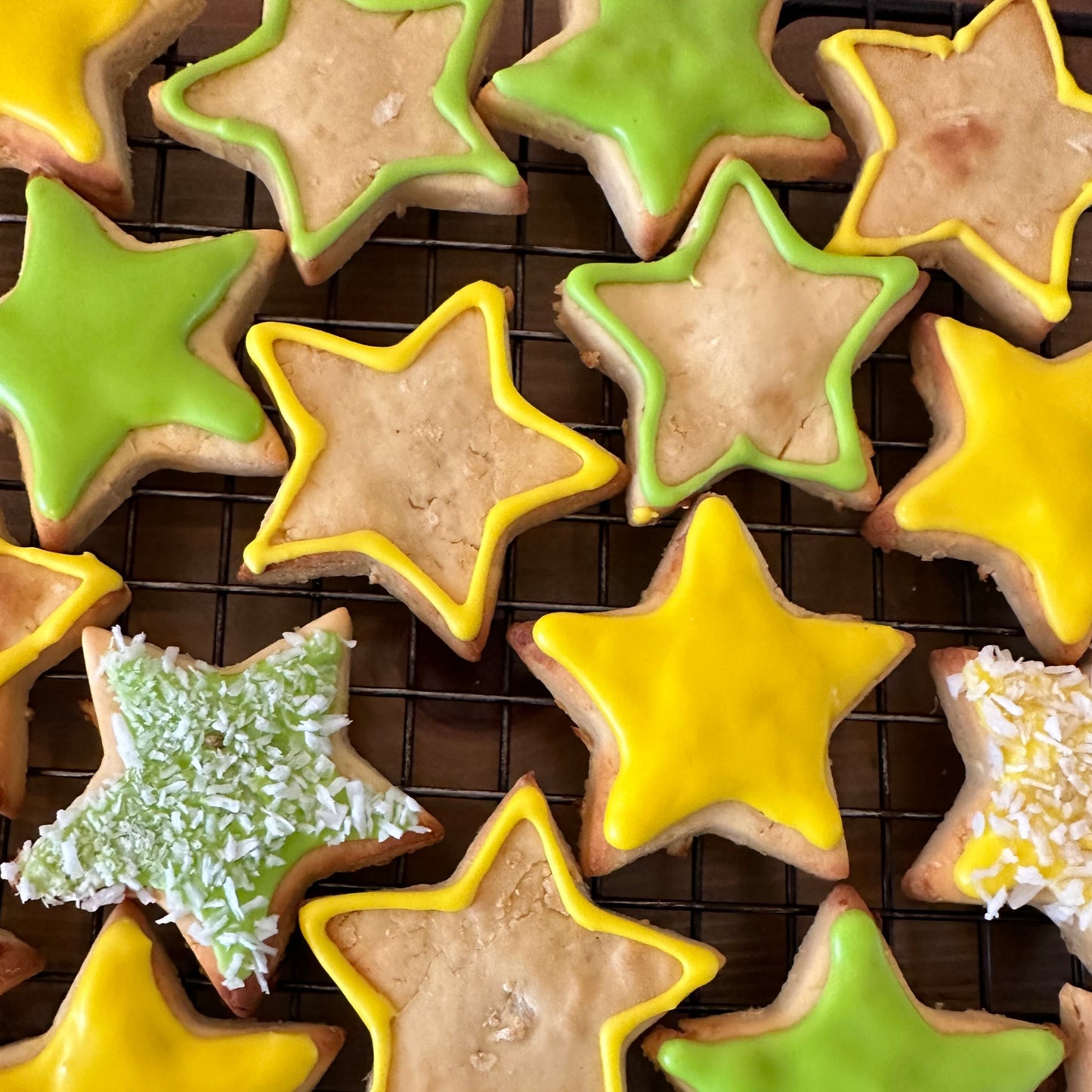 Star shaped dog biscuits with green and yellow icing