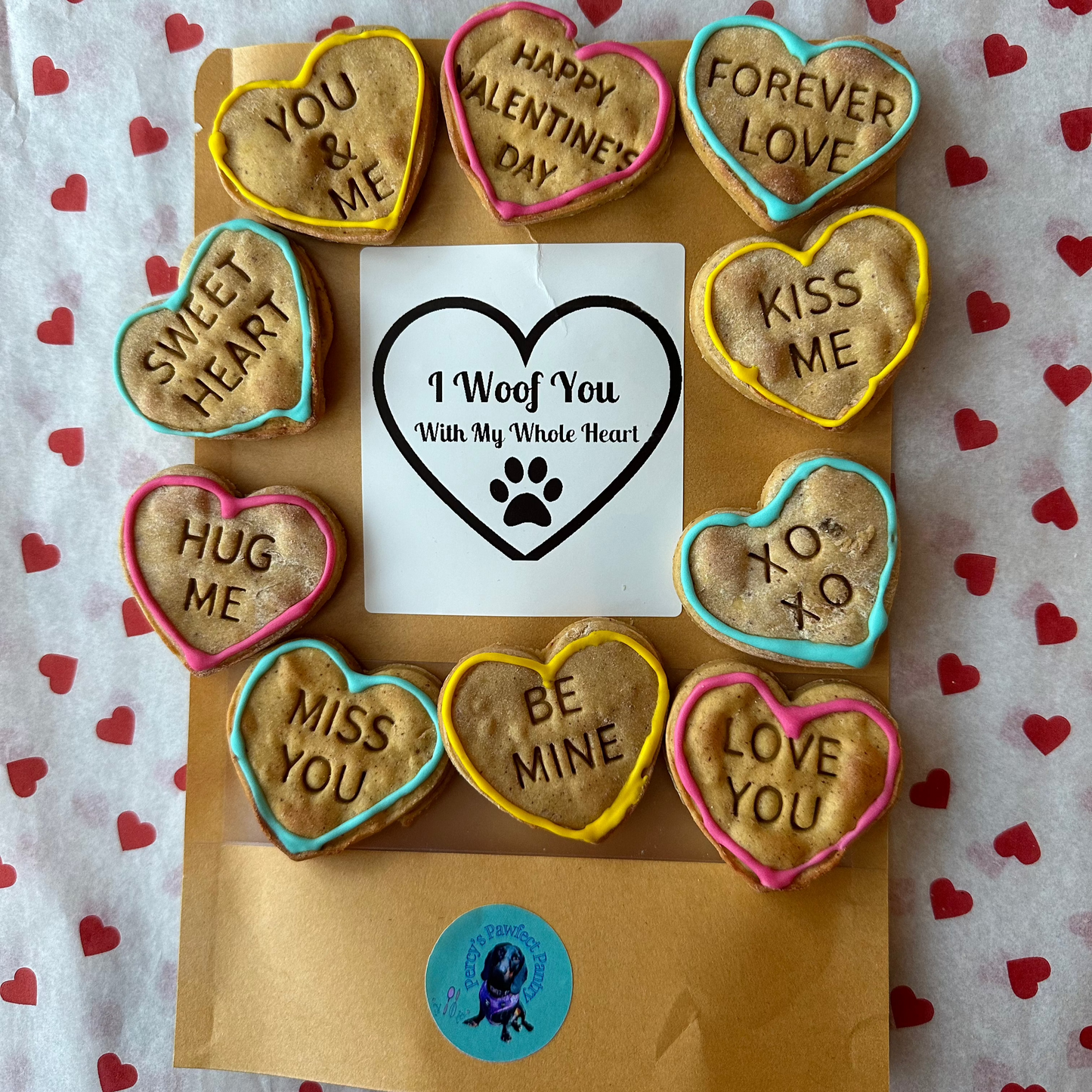 A treat bag surrounded by love heart dog biscuits