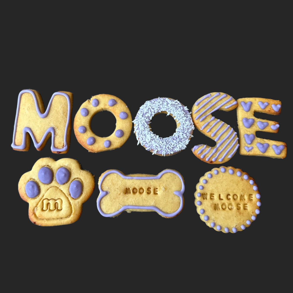 A selection of dog biscuits spelling "MOOSE"