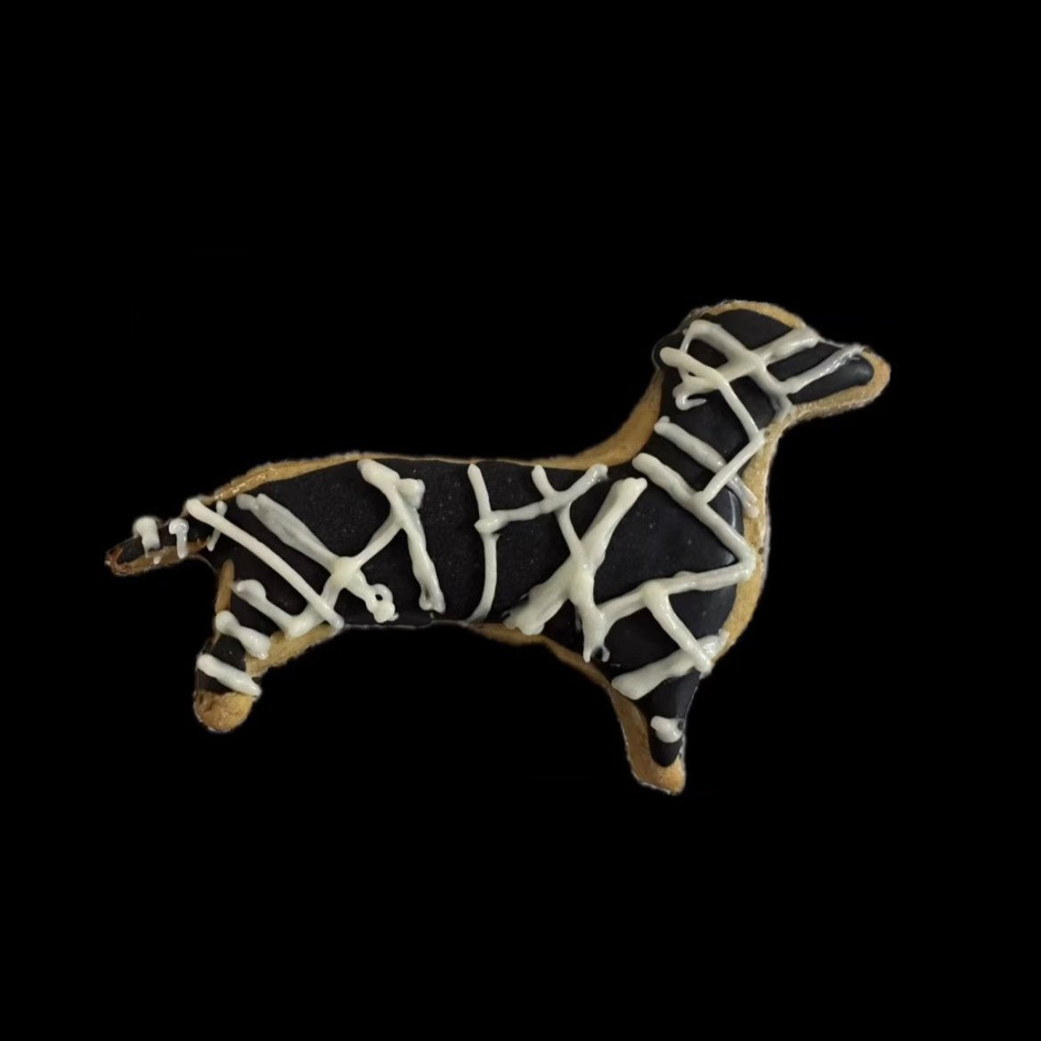 A decorated dog biscuits shaped like dachshund with a mummy design