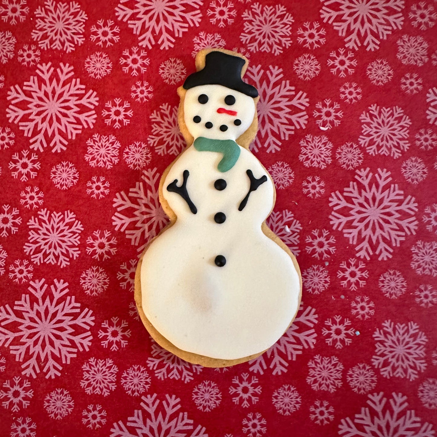 A Snowman dog biscuit on a red background