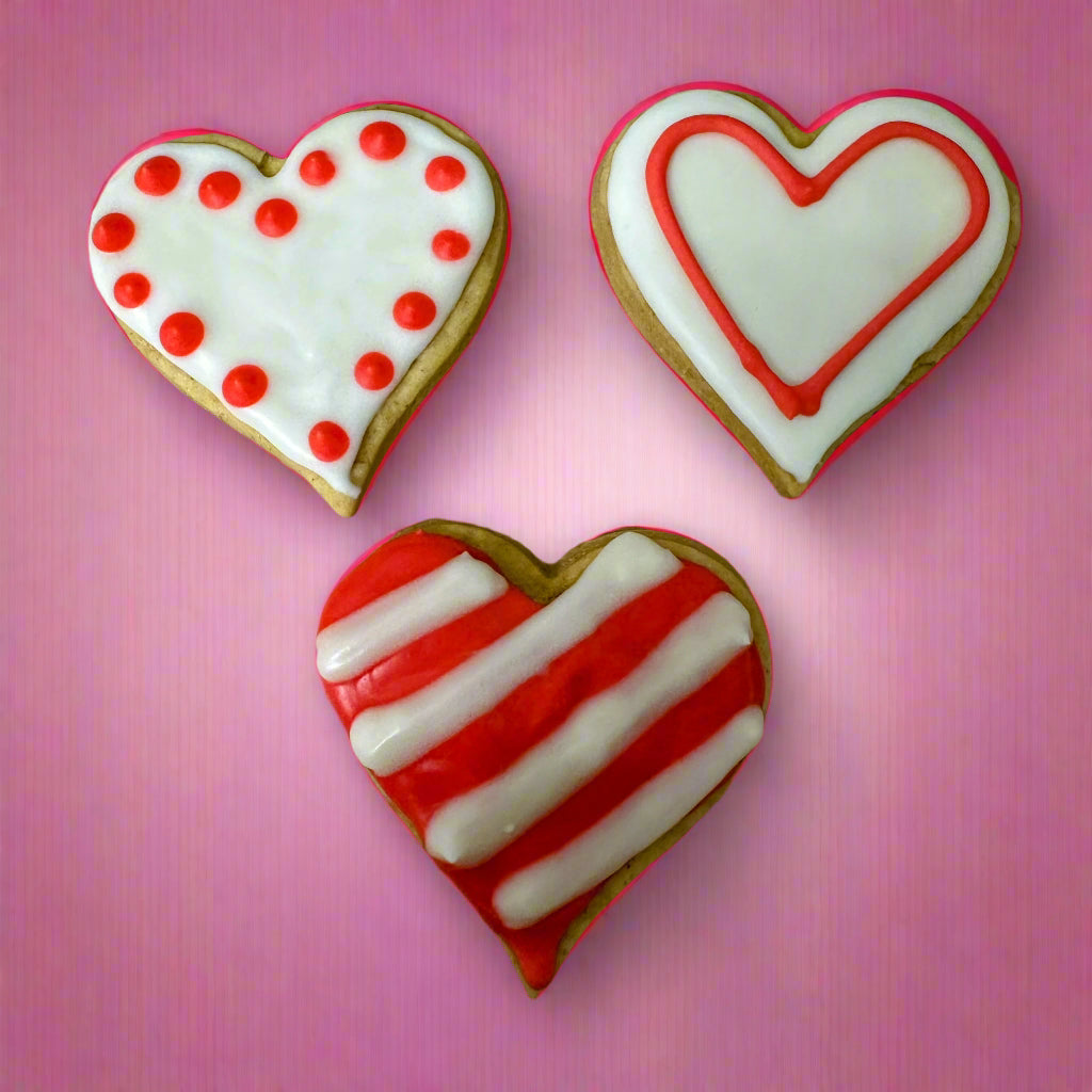 Set of 3 large heart-shaped dog biscuits with red and white icing