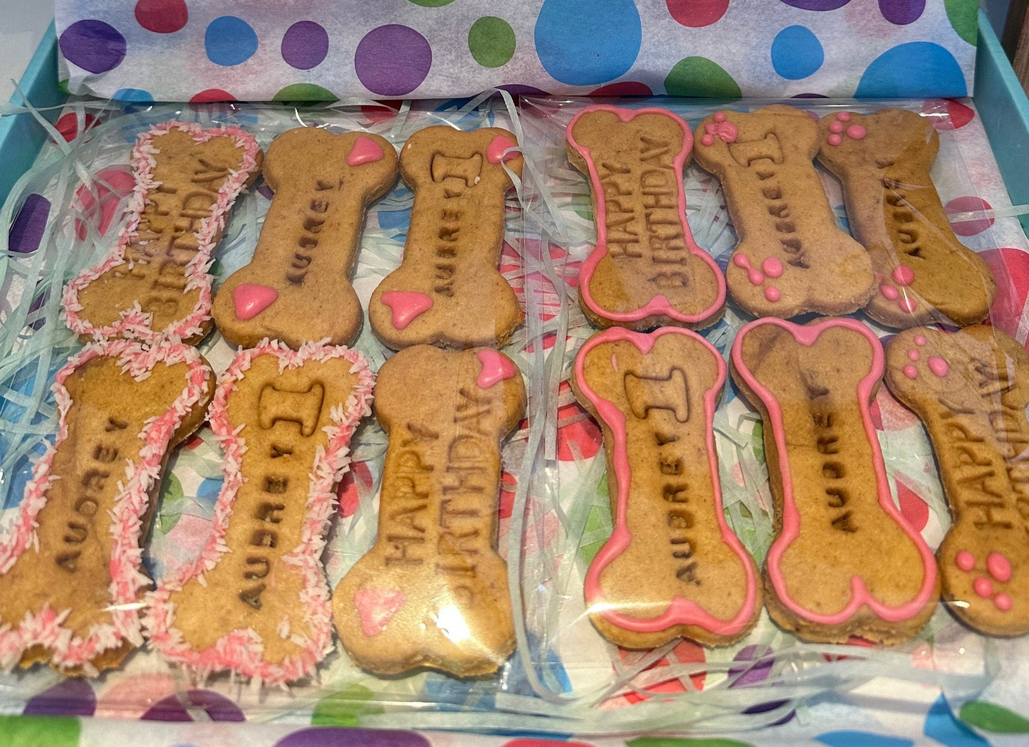 Bone-shaped dog biscuits decorated with white and pink icing