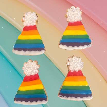 Four rainbow-coloured party hat cookies with white frosting on a colourful background