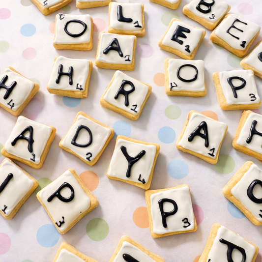 Custom letter dog biscuits arranged as Scrabble-style tiles