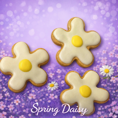 Three flower-shaped cookies with white icing and yellow centers on a purple floral background.