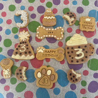 Collection of dog-themed birthday cookies on a polka dot background