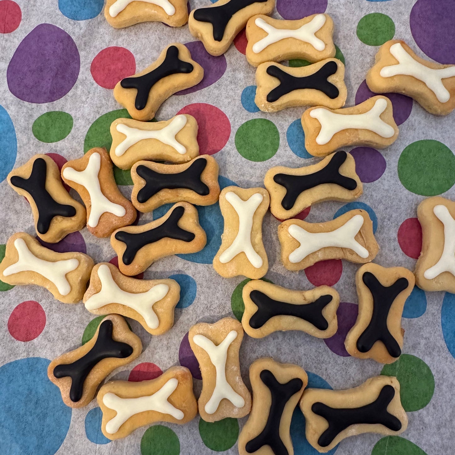 A selection of mini bone biscuits with black and white icing