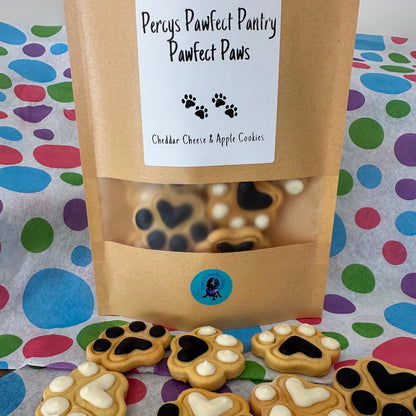 A packaged dog treat bag labeled 'Pawfect Paws' with visible treats shaped like paws and hearts on a colorful background.