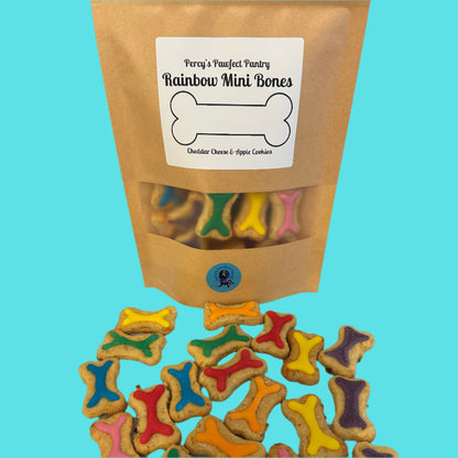 Bag of colorful dog treats shaped like bones on a white surface