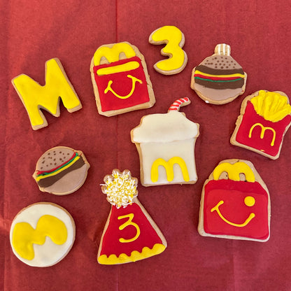 Decorative cookies shaped like McDonald's items on a red background