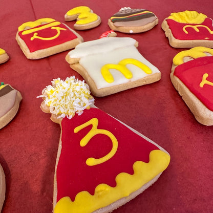 Cookie art resembling McDonald's logo and food items on a red background