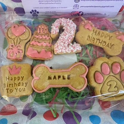 Dog birthday cookies with personalized text on a branded packaging background