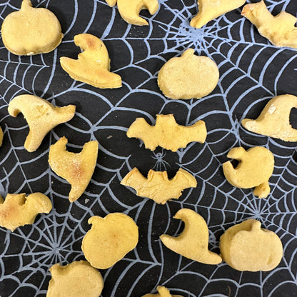 Halloween-themed cookies on a spider web background