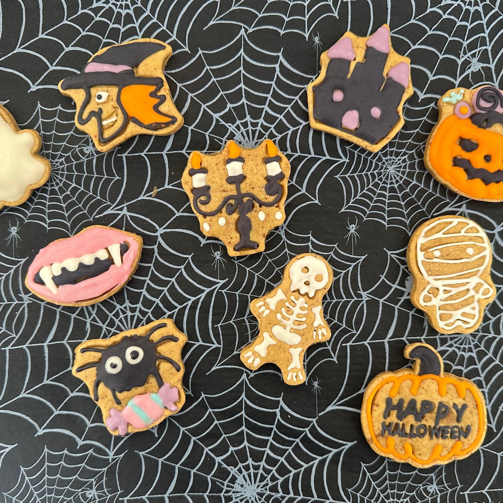 Halloween-themed cookies on a spider web background