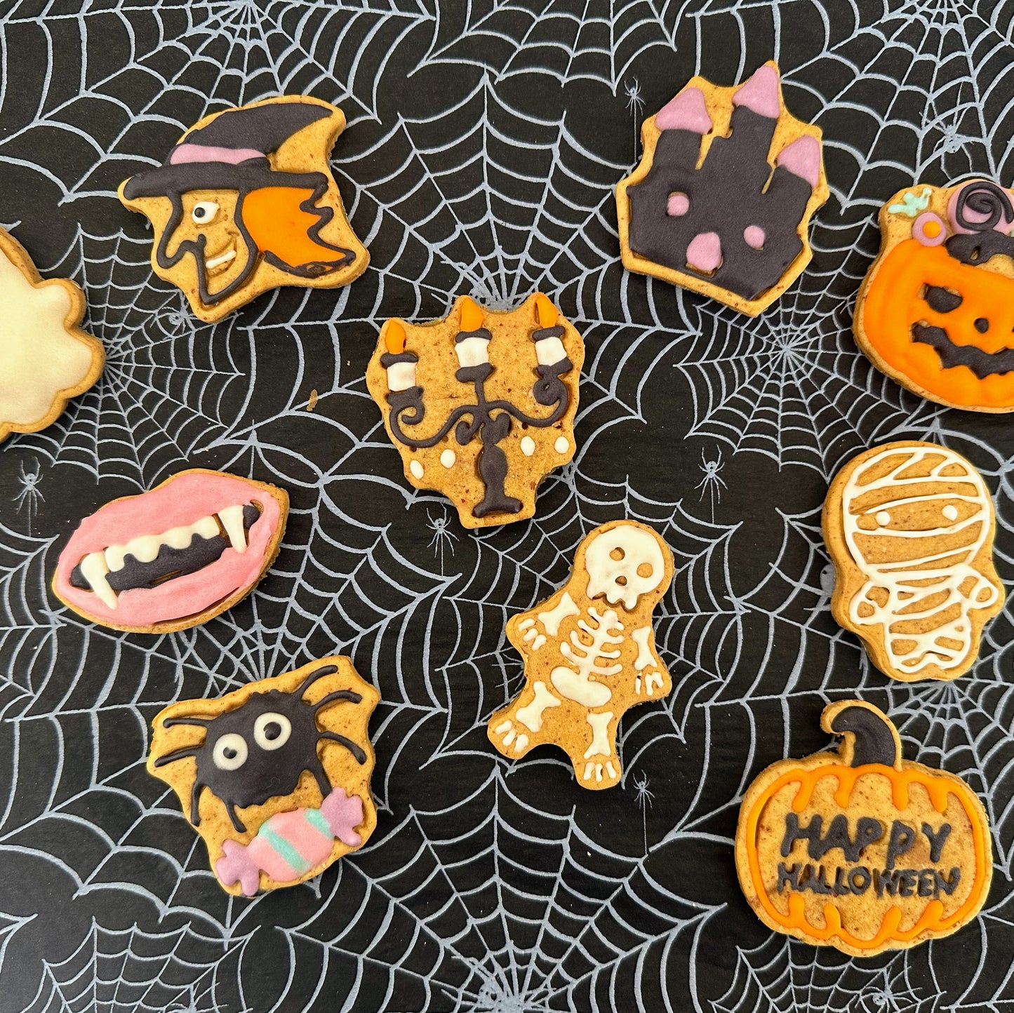 Halloween-themed cookies on a spider web background