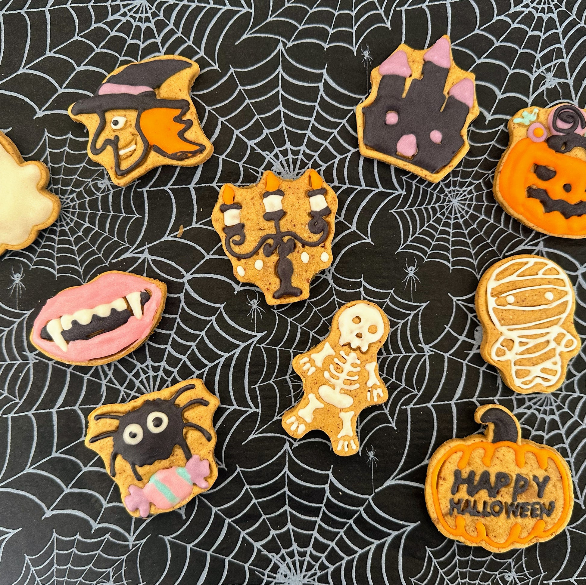 Halloween-themed cookies on a spider web background