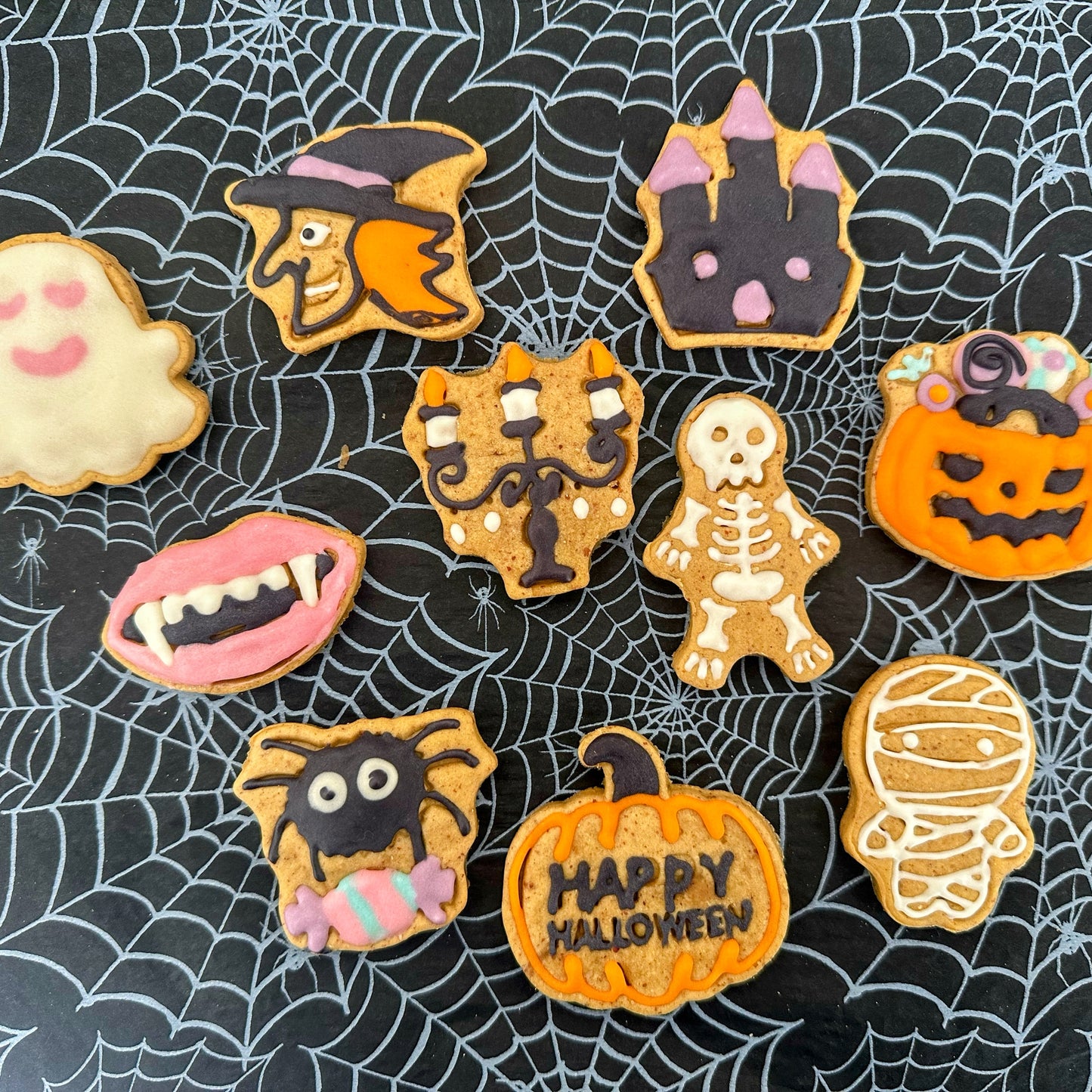 Halloween-themed cookies on a spider web background