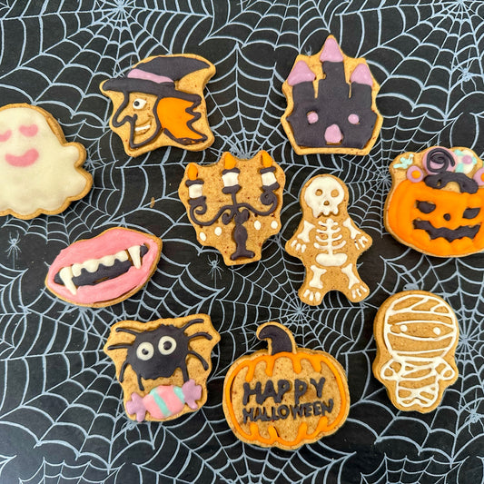 Halloween-themed cookies on a spider web background