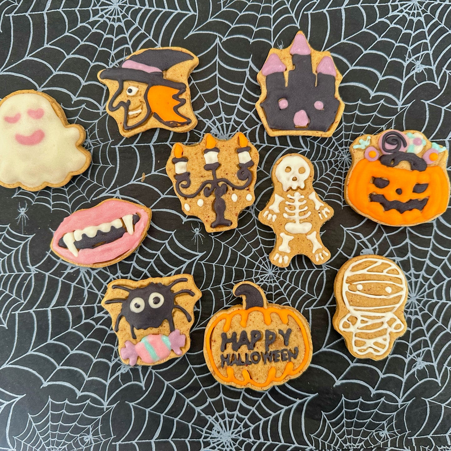 Halloween-themed cookies on a spider web background