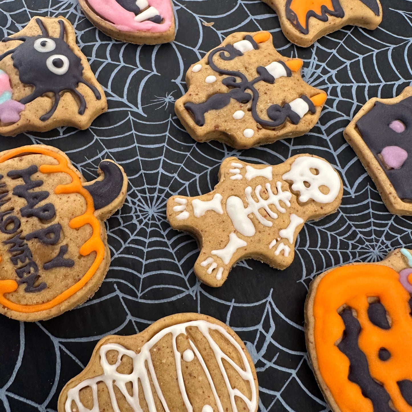 Halloween-themed cookies on a spider web background