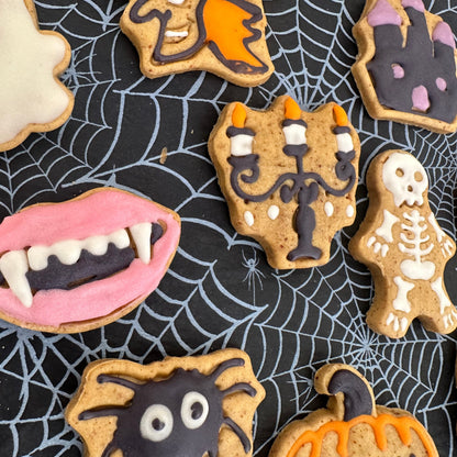 Halloween-themed cookies on a spider web background