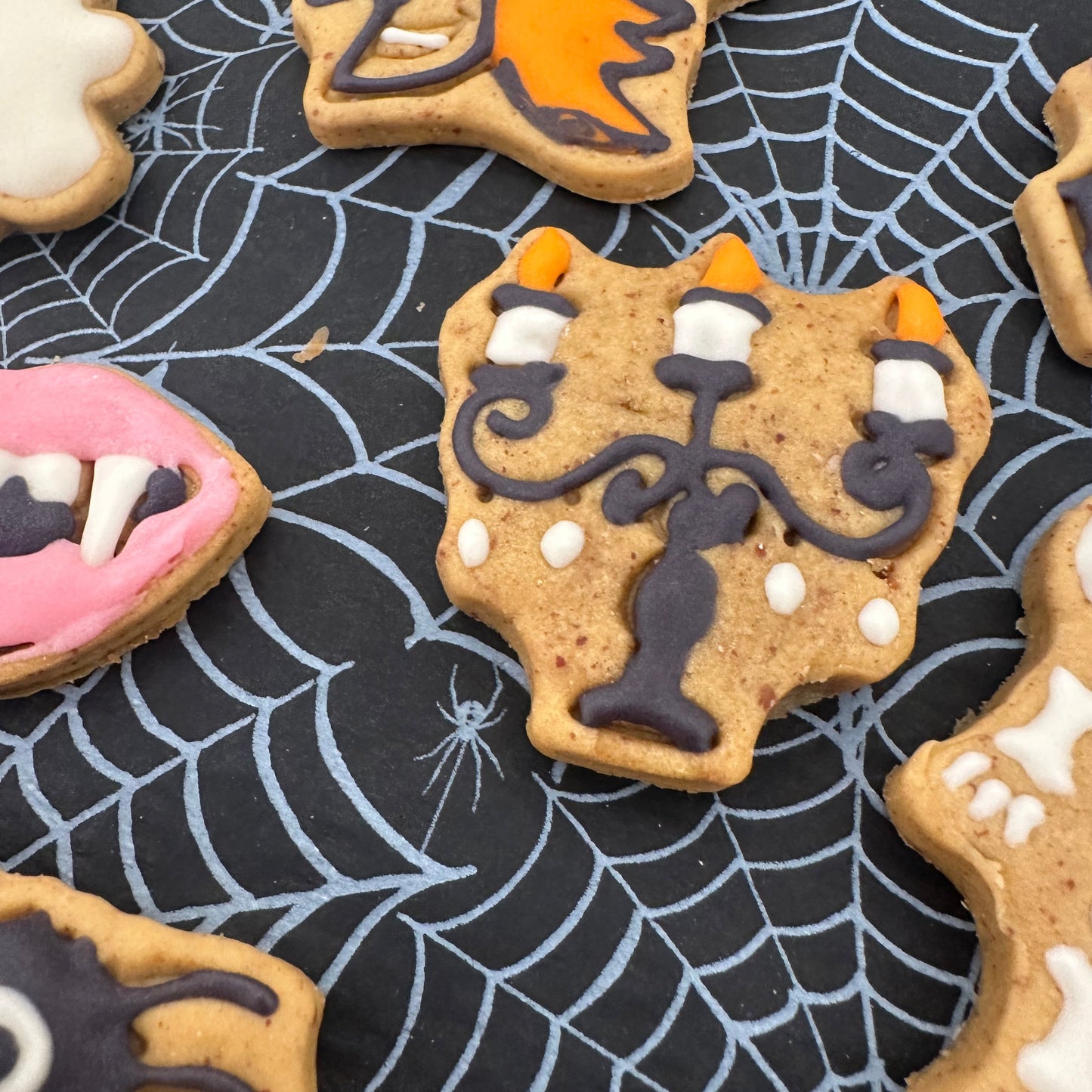 Halloween-themed cookies on a spider web background