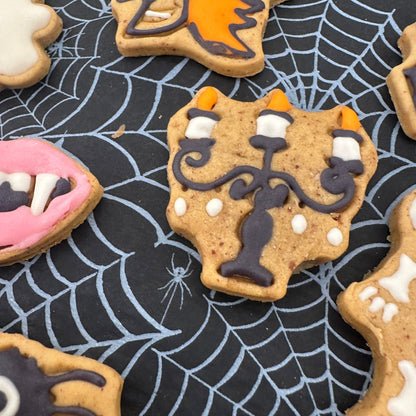 Halloween-themed cookies on a spider web background