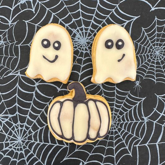 Halloween-themed cookies on a spider web background