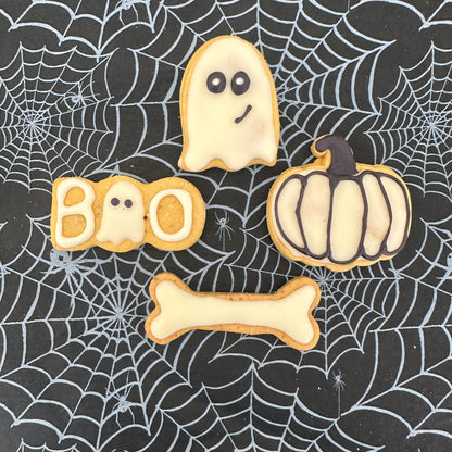 Halloween-themed cookies on a spider web background