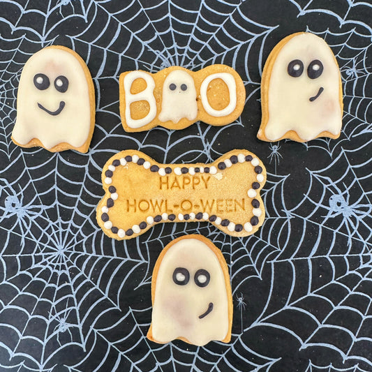 Halloween-themed cookies on a spider web background