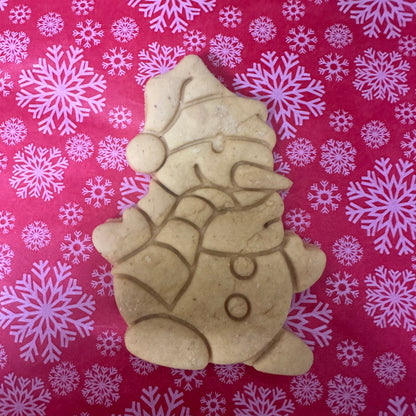Decorative cookie of a snowman on a red background with white snowflakes