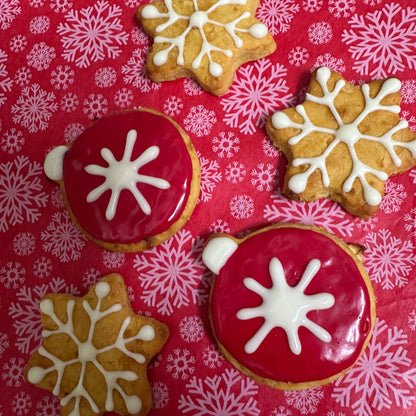 Decorative cookies with snowflake designs on a red and white patterned background
