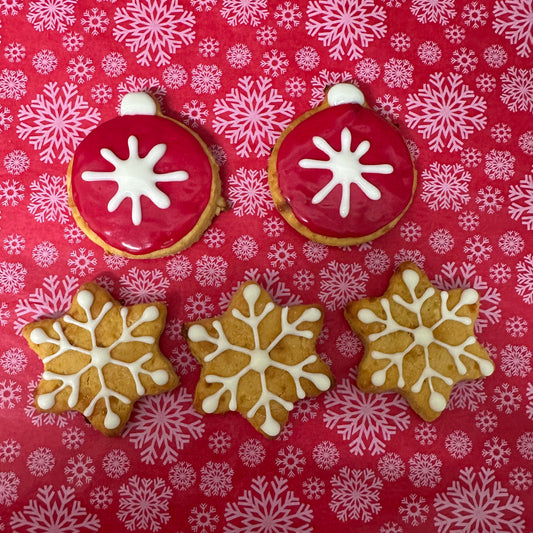 Decorative cookies with snowflake designs on a red background with snowflake pattern