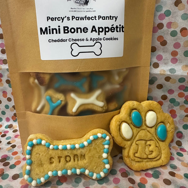 Packaged dog treats with a bone-shaped cookie on a polka dot background