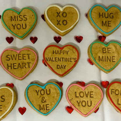 Heart-shaped cookies with Valentine's Day messages on a white background