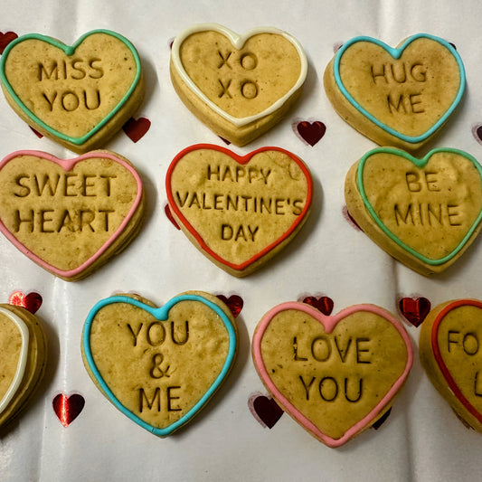 Heart-shaped cookies with Valentine's Day messages on a white background
