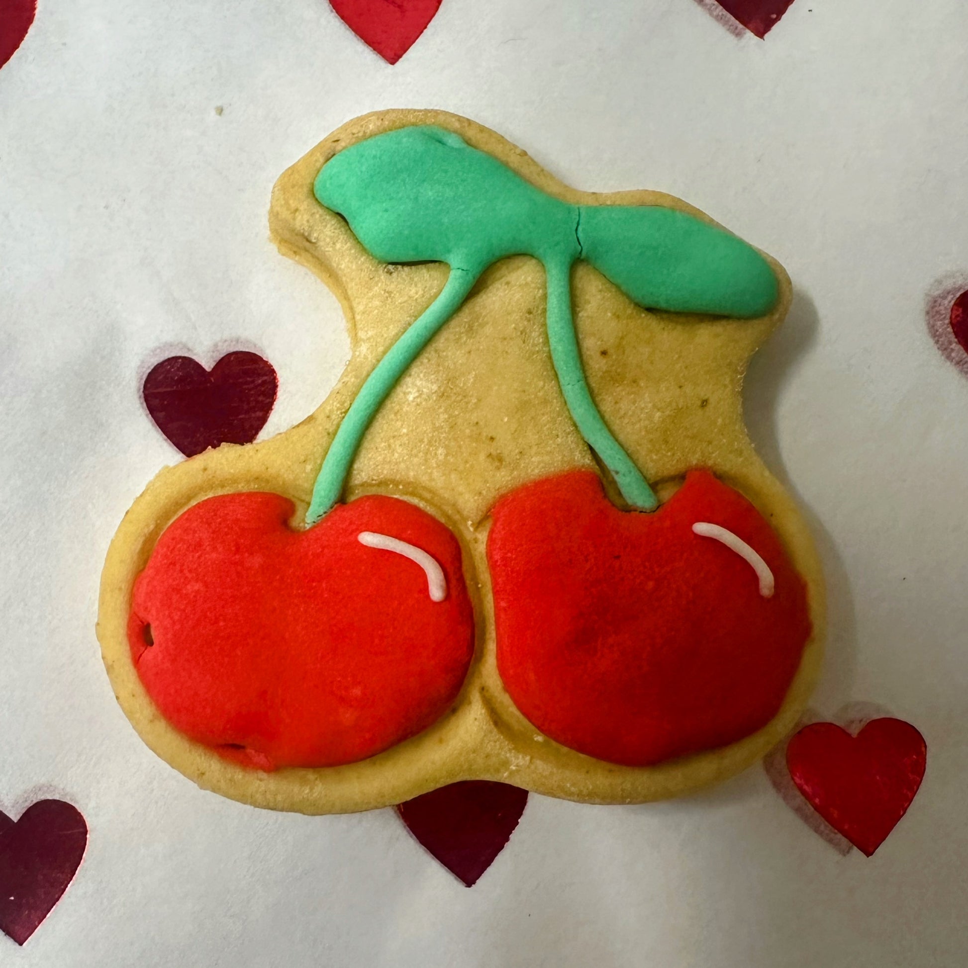 Valentine’s dog biscuits: cute cherry-shaped biscuits with red icing, green tops.