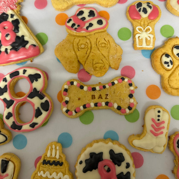 Decorative cookies shaped like bones and hearts on a polka dot background