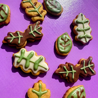 Decorative cookies with leaf designs on a purple background