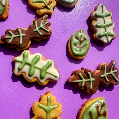 Decorative cookies shaped like leaves on a purple background