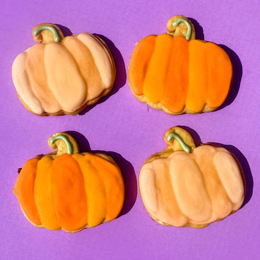Set of four pastel pumpkin dog biscuits for autumn