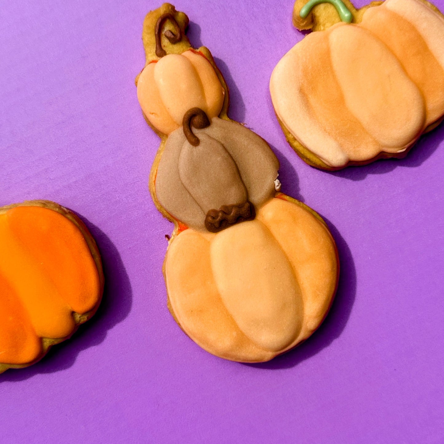 Pumpkin-shaped cookies on a purple background