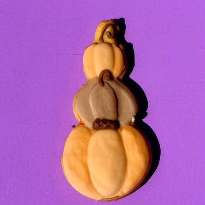 Decorative gourd with three stacked sections on a purple background
