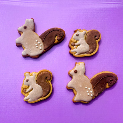 Four squirrel-shaped cookies on a purple background