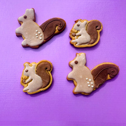 Four squirrel-shaped cookies on a purple background