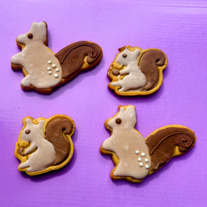 Four squirrel-shaped cookies on a purple background