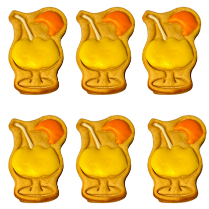 Six cookies shaped like glasses with lemon slices on a white background