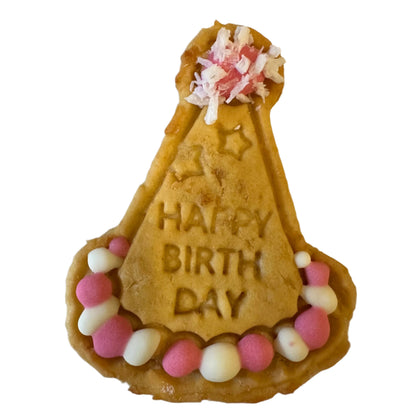 Dog party hat-shaped cookie with 'Happy Birthday' text and colourful dots  on a white background